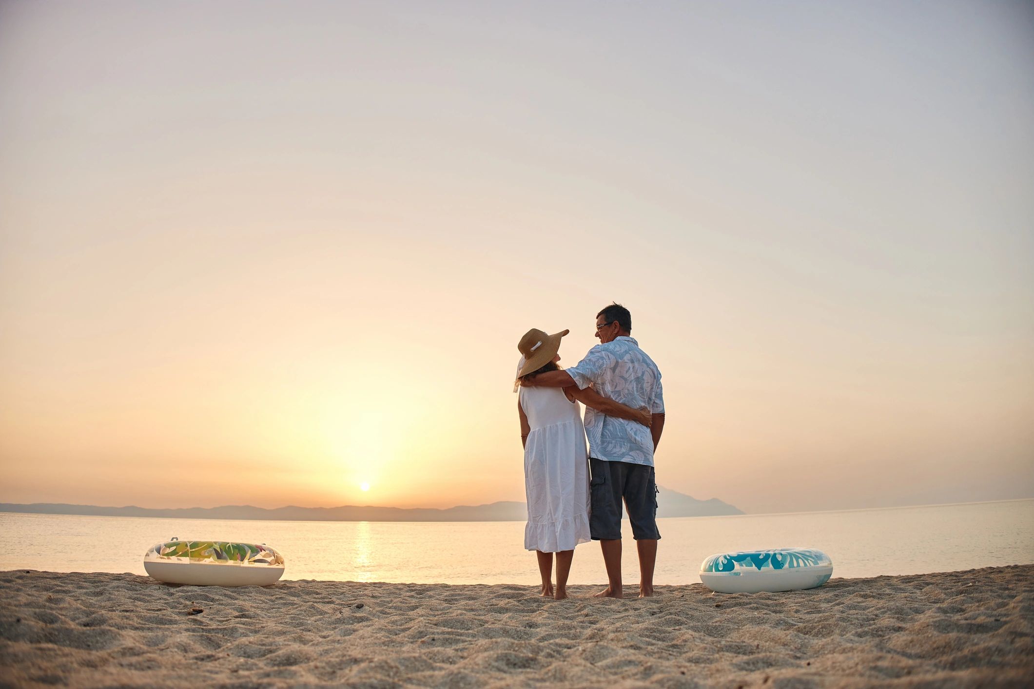 Couple enjoying a beach sunset at a resort